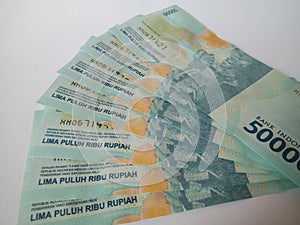 Indonesian bank notes. 50000 rupiah banknotes. Blue banknotes. White isolated background . Means of payment