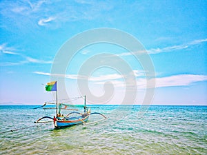 Indonesian boat in Pasir Putih beach photo