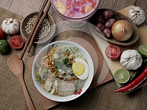 Indonesian chicken soto or soto ayam, served with ketupat or lontong