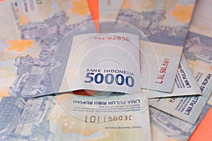 The Indonesian currency is rupiah, which is very much scattered and is worth fifty hundred thousand rupiah. Isolated in orange