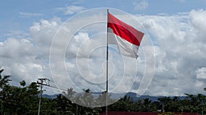 Indonesian flag with blurry cloud, bendera merah putih on indonesian independence day. photo