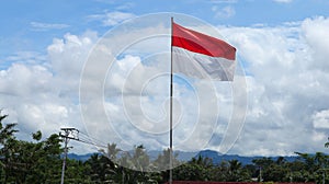 Indonesian flag with blurry cloud, bendera merah putih on indonesian independence day. photo