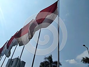 Indonesian flag flying on pole to commemorate independence day 76th in Senayan, South Jakarta, Indonesia