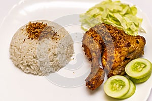 Indonesian food ayam goreng serundeng served with rice and veggies