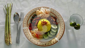 Indonesian food named nasi kuning with sauce