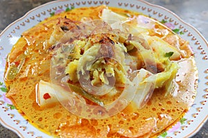 Indonesian food, namely rice cake topped with bakwan - close up