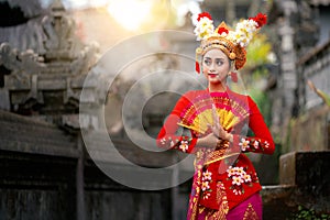 Indonesian girl with traditional costumn dance in bali temple