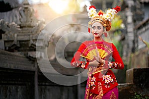 Indonesian girl with traditional costumn dance in bali temple photo
