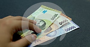 Indonesian man hand holding rupiah money. Indonesian currency. cash in hand concept and close up view