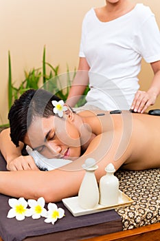 Indonesian man at hot stone wellness massage