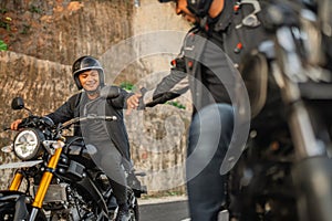 indonesian man riding motorbike hand shake