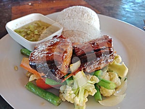 Indonesian meal composed of meat, vegetables and rice with sweat sauce