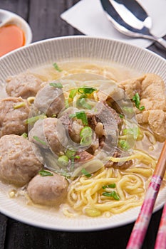 Indonesian Meatball Bakso Noodle with sweet soy sauce and chilli sauce sprinkle with green onion photo