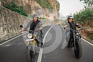 indonesian men enjoying riding motorcycle outdoors