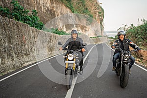 indonesian men enjoying riding motorcycle outdoors