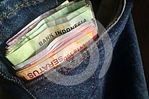 Indonesian money in a blue jeans pocket photo