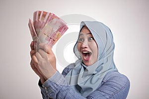 Indonesian Muslim Woman Holding Rupiah Money