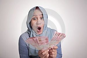 Indonesian Muslim Woman Holding Rupiah Money