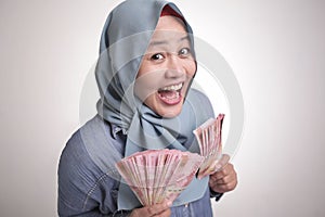 Indonesian Muslim Woman Holding Rupiah Money