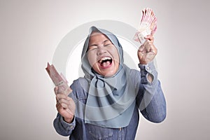 Indonesian Muslim Woman Holding Rupiah Money