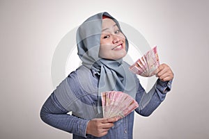 Indonesian Muslim Woman Holding Rupiah Money