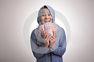 Indonesian Muslim Woman Holding Rupiah Money