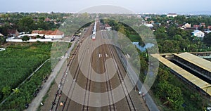 Indonesian passenger train KAI traveling on the rail from aerial view