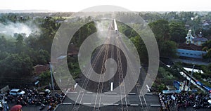 Indonesian passenger train KAI traveling on the rail from aerial view