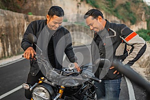 indonesian riders checking motorbike fuel tank