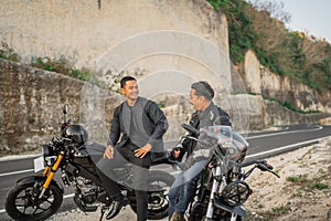 indonesian riders wearing jacket sitting on motorbike