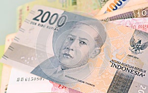 Indonesian rupiah banknote on another Southeast-asian currency