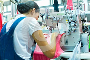 Indonesian Seamstress in Asian textile factory photo