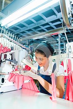 Indonesian Seamstress in Asian textile factory