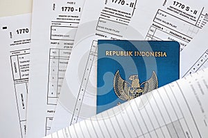 Indonesian tax forms 1770 Individual Income Tax Return and passport on table
