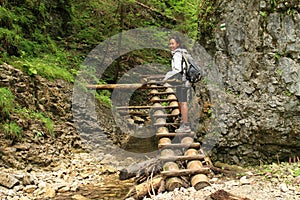 Tourist on wooden ladders in Slovak Paradise