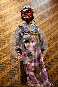 Wayang golek with batik background photo