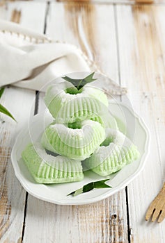 Indonesian Traditional steamed cake Kue Putu Ayu, made from rice flour, grated coconut, pandanus and suji leaves