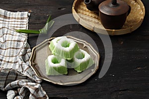 Indonesian Traditional steamed cake Kue Putu Ayu, made from rice flour, grated coconut, pandanus and suji leaves, served in plate