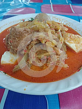 Indonesian traditional street food with spicy sauce, lontong sayur