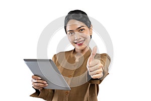 Indonesian woman in civil servant uniform with thumbs up while using tablet