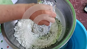 An Indonesian woman grates coconut