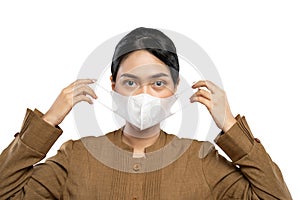 Indonesian women in civil servant uniforms wearing masks