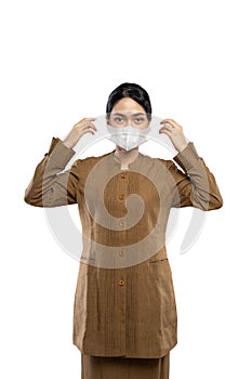 Indonesian women in civil servant uniforms wearing masks