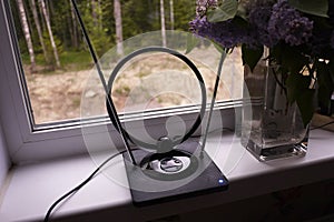 Indoor antenna for receiving TV signal. Set near the window and catches the TV. Details and close-up. photo