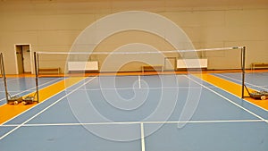 Indoor badminton court seen from the side of the player