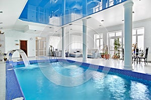Indoor big blue swimming pool interior