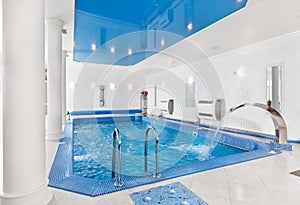 Indoor big blue swimming pool interior