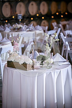 Indoor dinner setting for a wedding ceremony event with flowers and candles