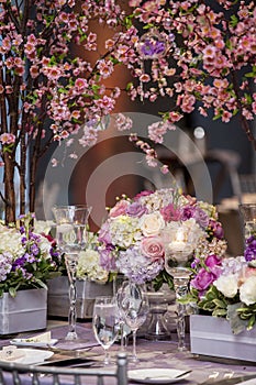 Indoor dinner setting for a wedding ceremony event with flowers and candles
