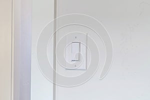 Indoor electrical light switch of home mounted on white wall background